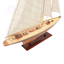 Load image into Gallery viewer, Between the cabins is a miniature handmade wooden lifeboat. The stitched sail and intricate rigging complete the definition of a true sailing boat.
